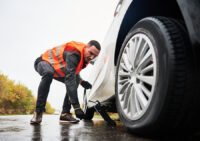 emergency-mechanic-lifting-vehicle-with-car-jack-street